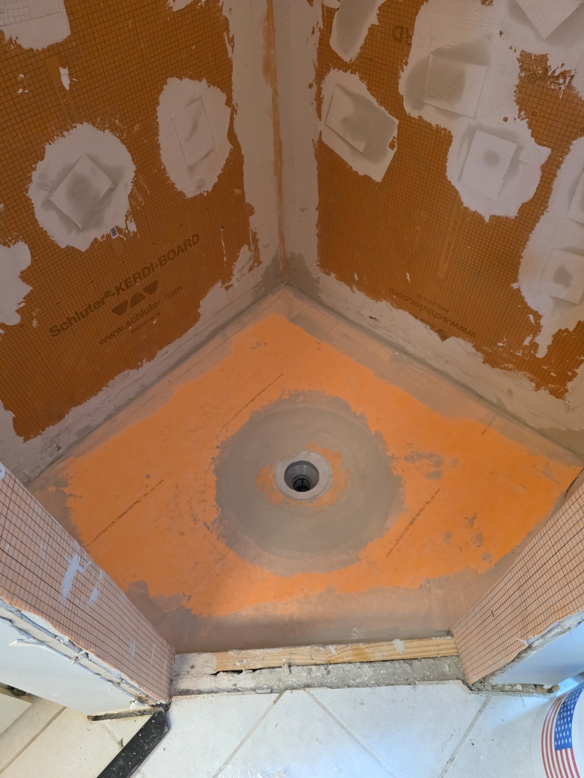Shower base and drain preparation before pebble tile installation